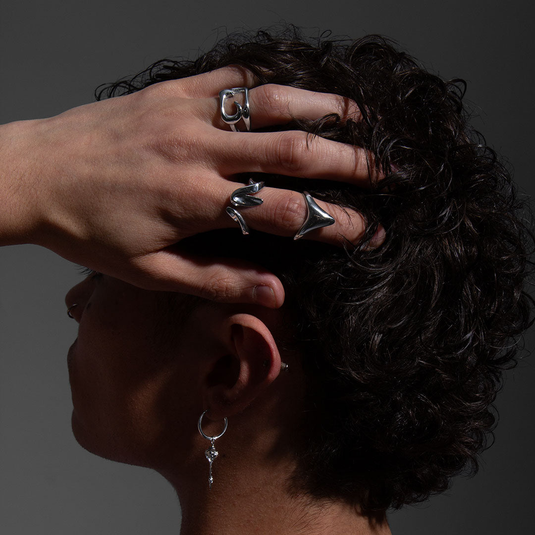 EQUINOX RING worn on a man's hand combined with several pieces of jewelry