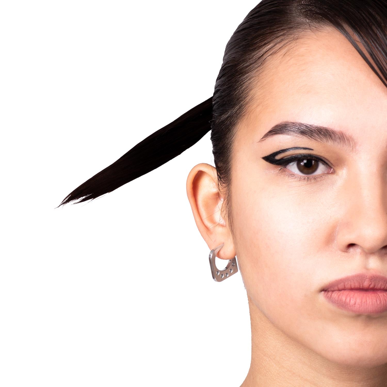 PENTAGON EARRING made of stainless steel worn on a woman's ear