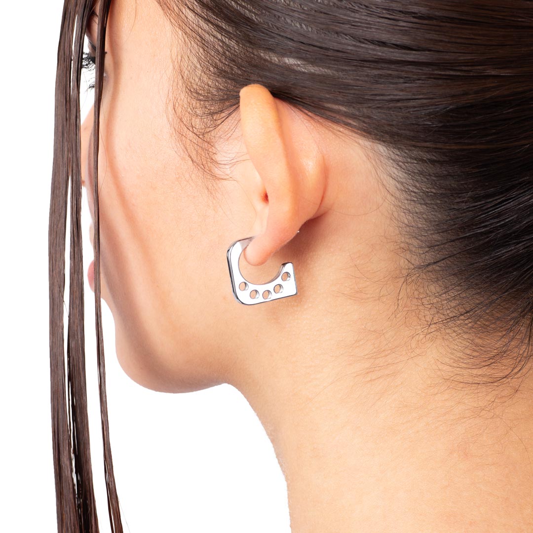 PENTAGON EARRING made of stainless steel worn on a woman's ear from the side view