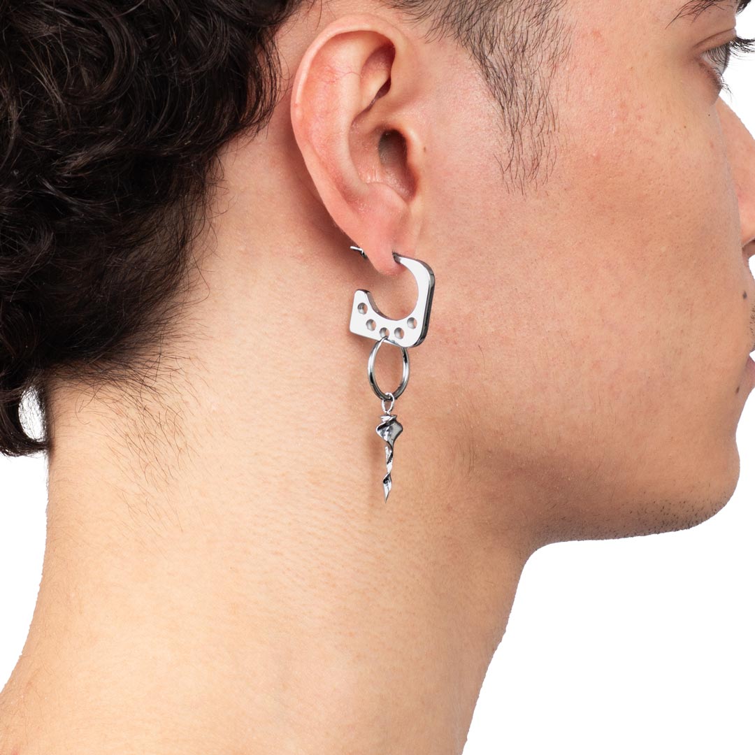 PENTAGON EARRING made of stainless steel worn on a man's ear from the side view. You can attach additional earrings through the extra holes in the earring