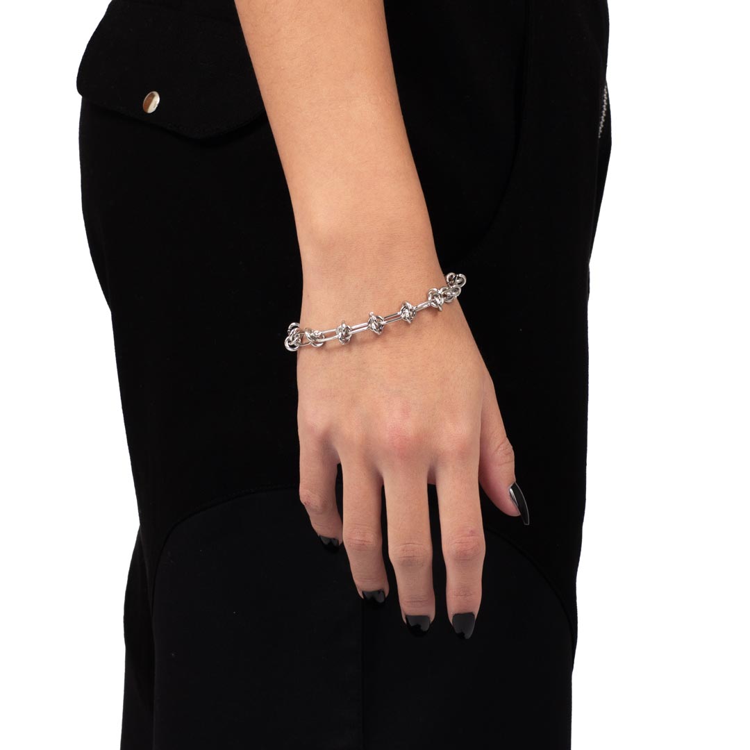 WIRE WEAVE BRACELET made of stainless steel worn close-up in a woman's hand