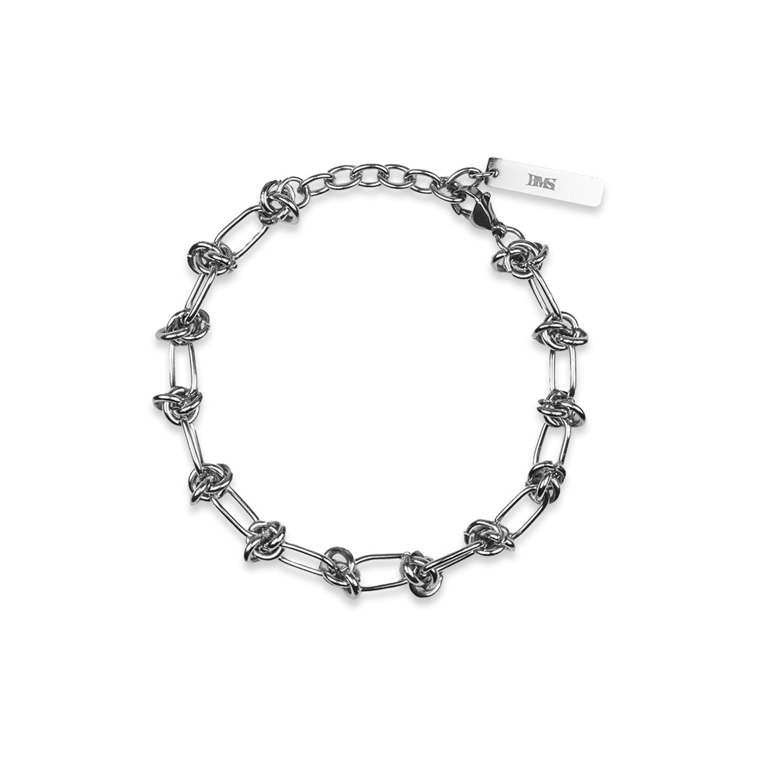 WIRE WEAVE BRACELET made of stainless steel in front view lying on a white background